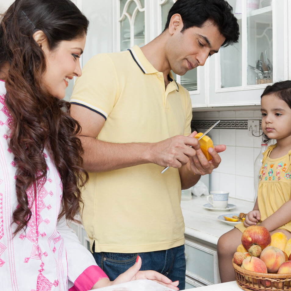 Young family in kitchen cooking
